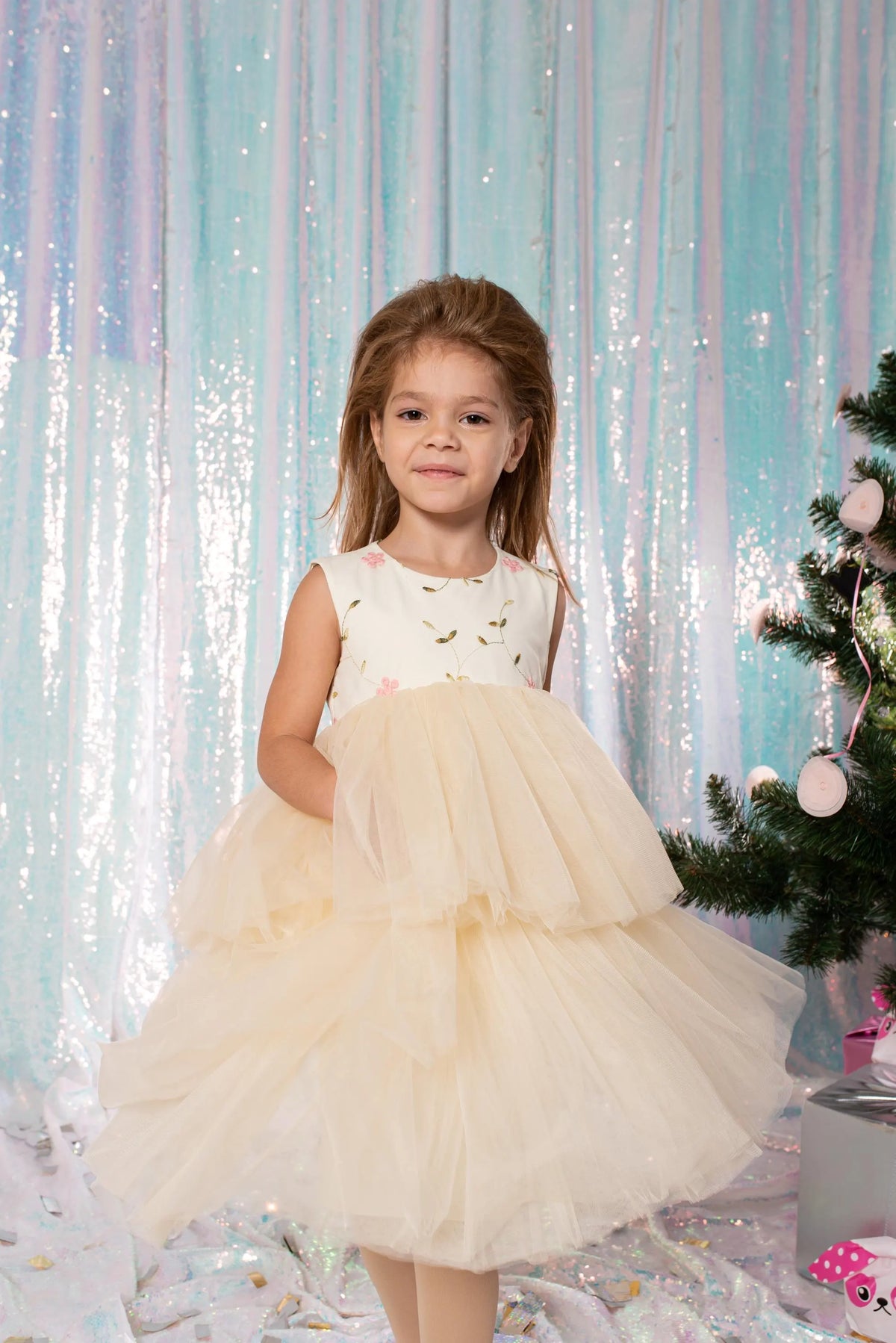 Girl modeling a white floral embroidered dress with a full two-tier tulle skirt for weddings and special occasions
