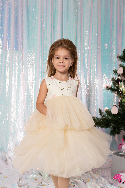 Girl modeling a white floral embroidered dress with a full two-tier tulle skirt for weddings and special occasions